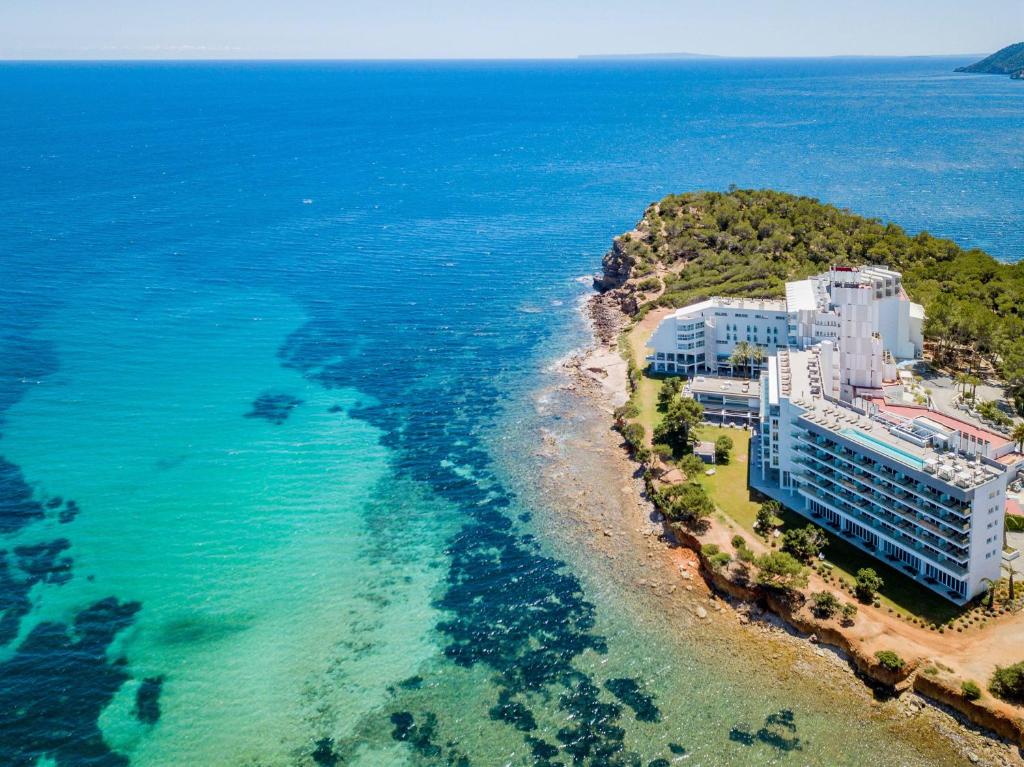 an aerial view of a hotel on an island in the ocean at Meliá Ibiza - Adults Only in Santa Eularia des Riu