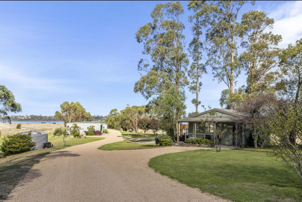 a home with a road leading to a house at Lawsons Retreat in St Helens