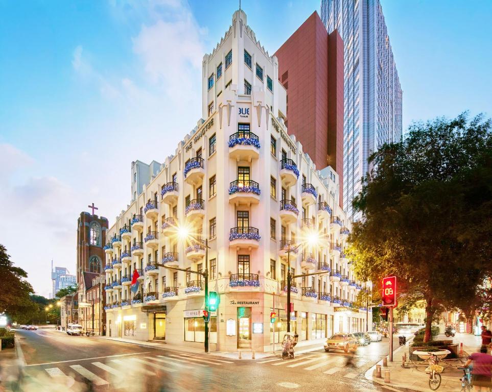 a large white building on a city street at night at TUI BLUE Yangtze Shanghai in Shanghai