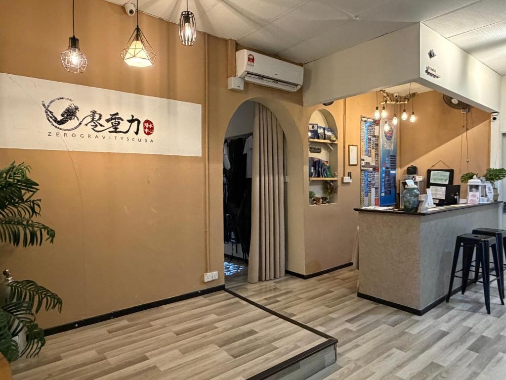 a lobby of a restaurant with a counter at Zero Gravity Homestay 零重力民宿 in Semporna