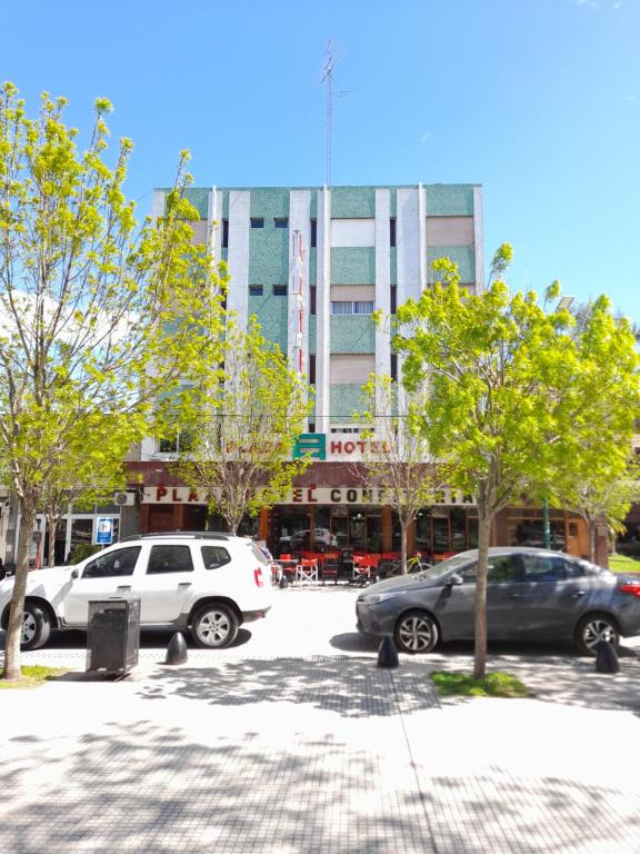 a parking lot with cars parked in front of a building at Plaza hotel in Dolores