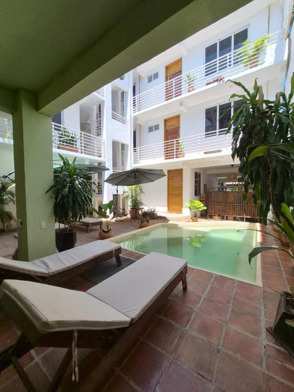 a swimming pool in front of a building at Sicarú, La Punta - Puerto Escondido in Brisas de Zicatela