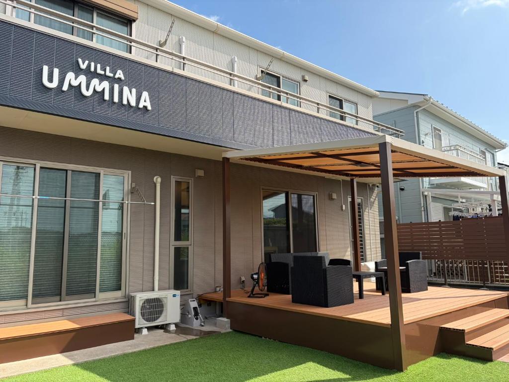a building with awning on the front of it at Villa UMMINA in Tahara