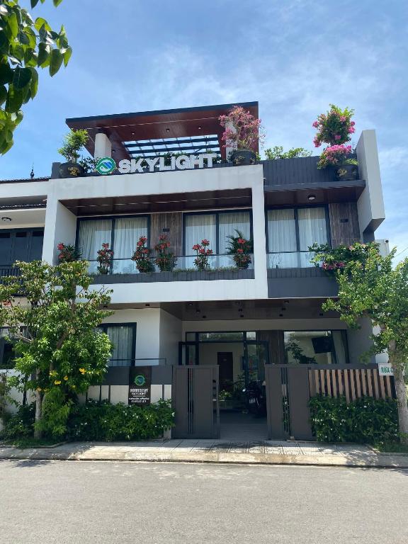 a building with flowers on the balconies of it at Homestay SkyLight in Dong Hoi