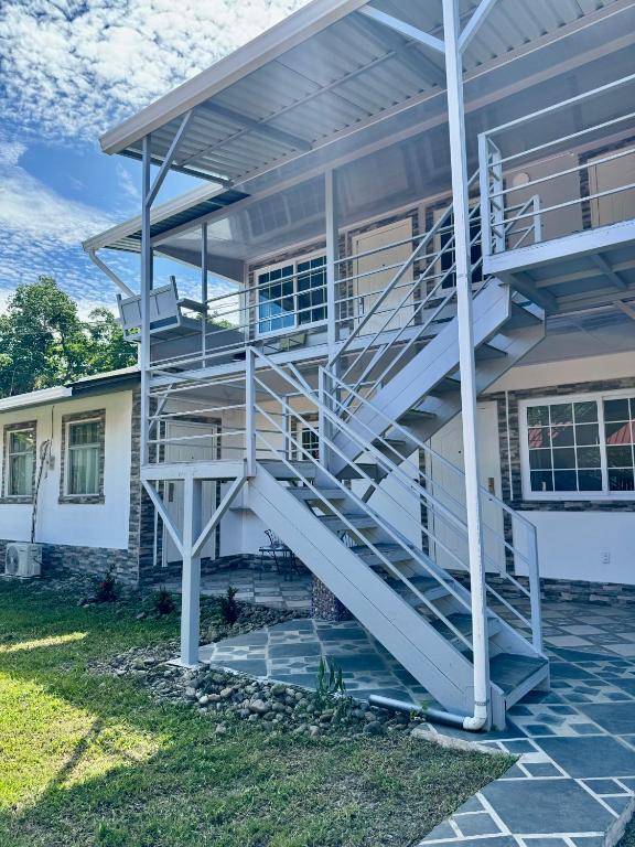 a spiral staircase on the side of a house at Villas Cozy Sloth in Puerto Viejo