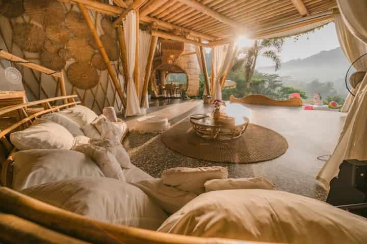 a room with a bunch of beds in it at Bamboo amazing villa sidemen in Selat