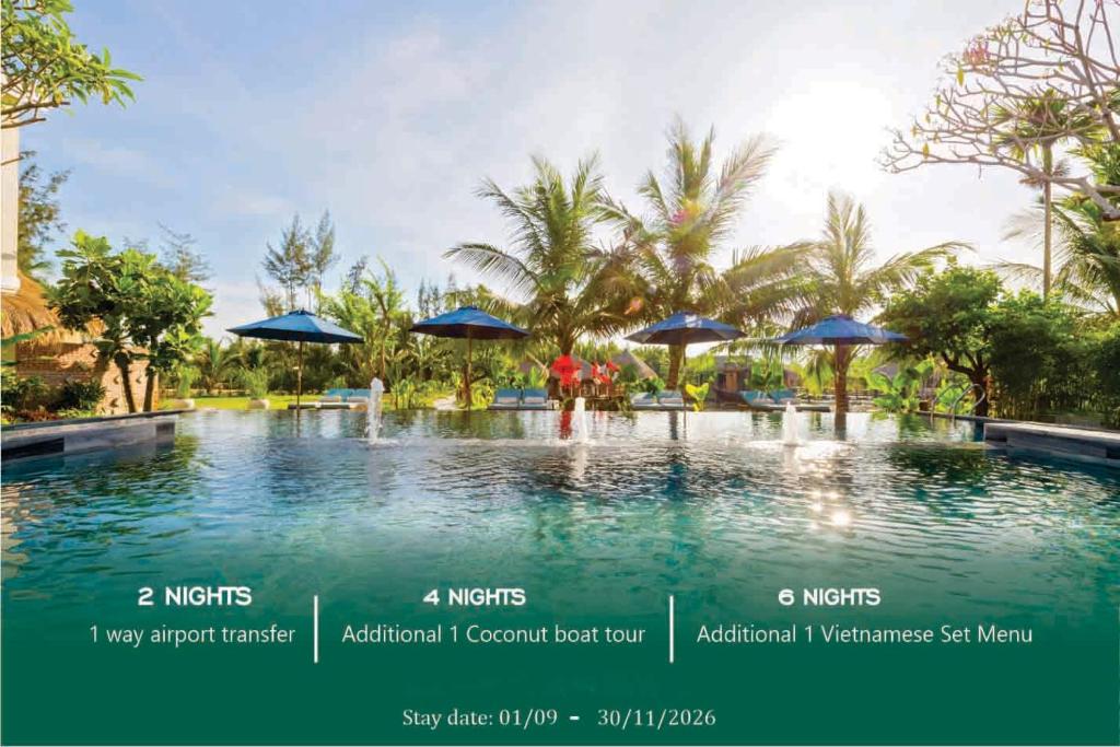 a swimming pool with umbrellas in a resort at Zest Resort & Spa Hoi An in Hoi An