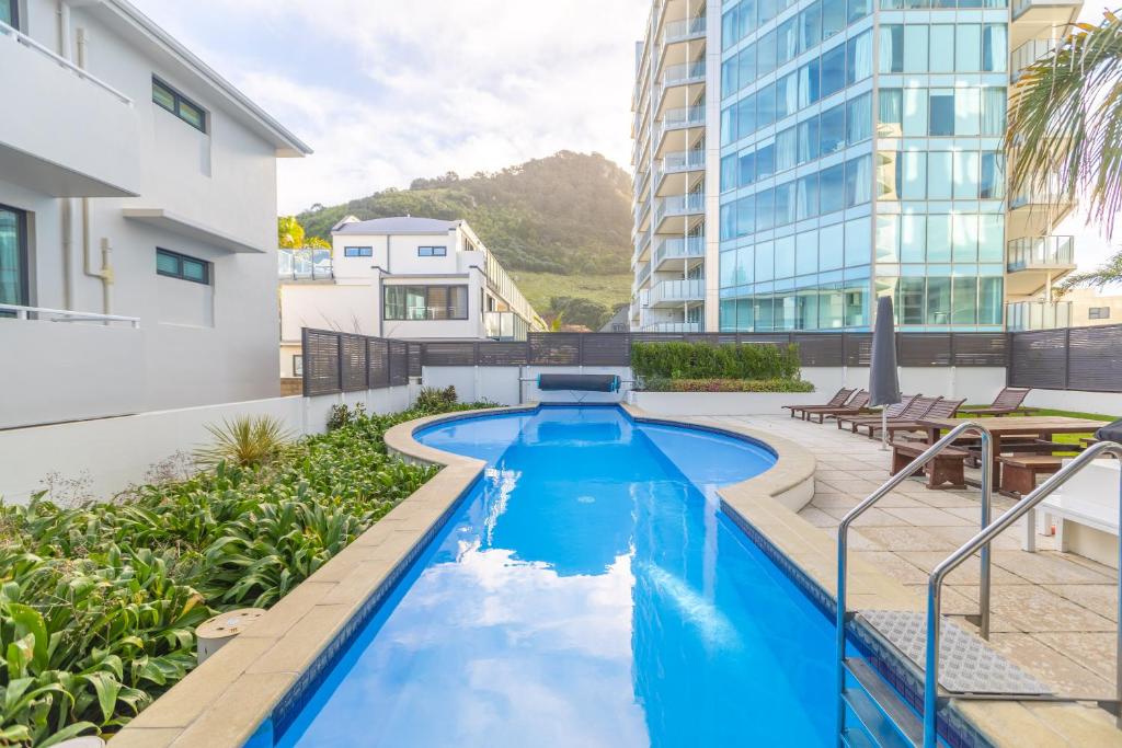 a swimming pool in the middle of a building at Capri on Pilot Bay in Mount Maunganui