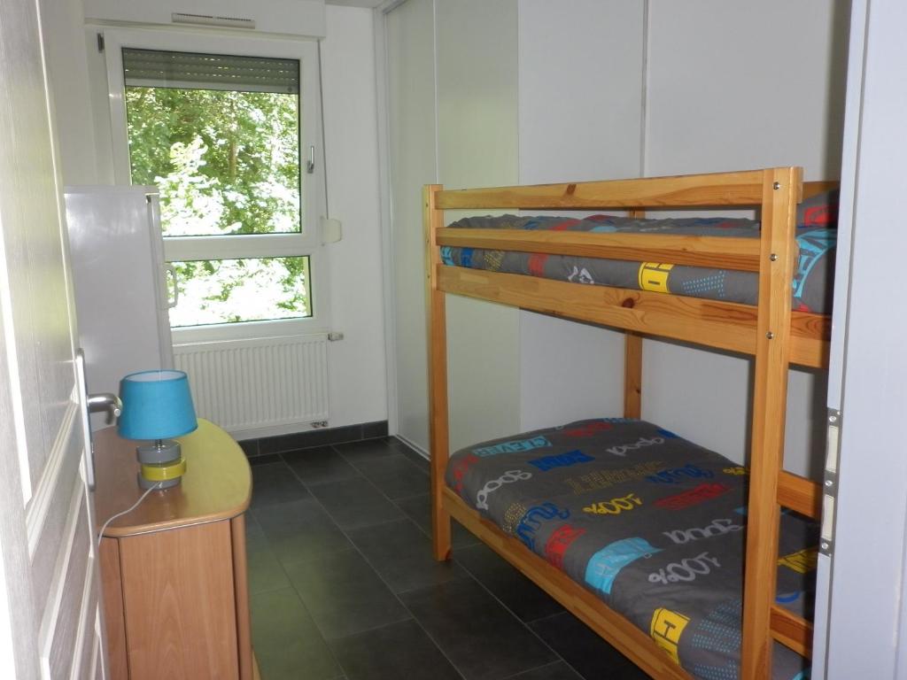 a bedroom with two bunk beds and a window at Villa Verdi in Ostheim