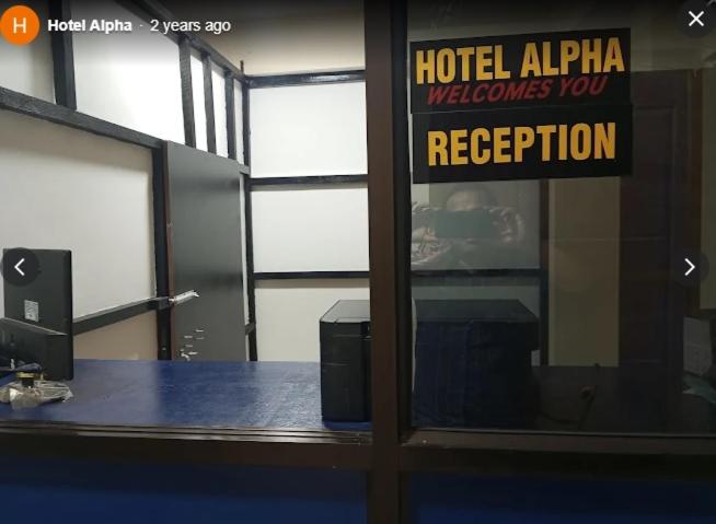 a door with a sign that reads hotel alpha welcomes you reception at Hotel Alpha in Imphal International Airport