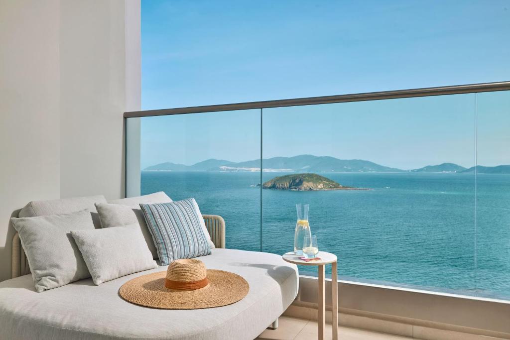 a room with a bed with a view of the ocean at Meliá Aurea Nha Trang in Nha Trang