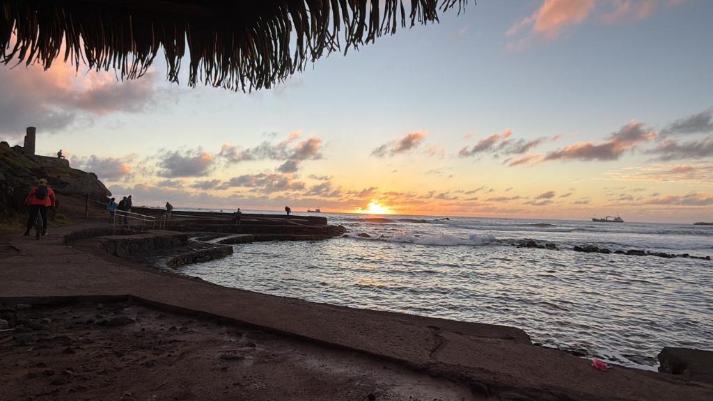 a sunset on a beach with the ocean at Cabaña Tea Tea 2 in Hanga Roa