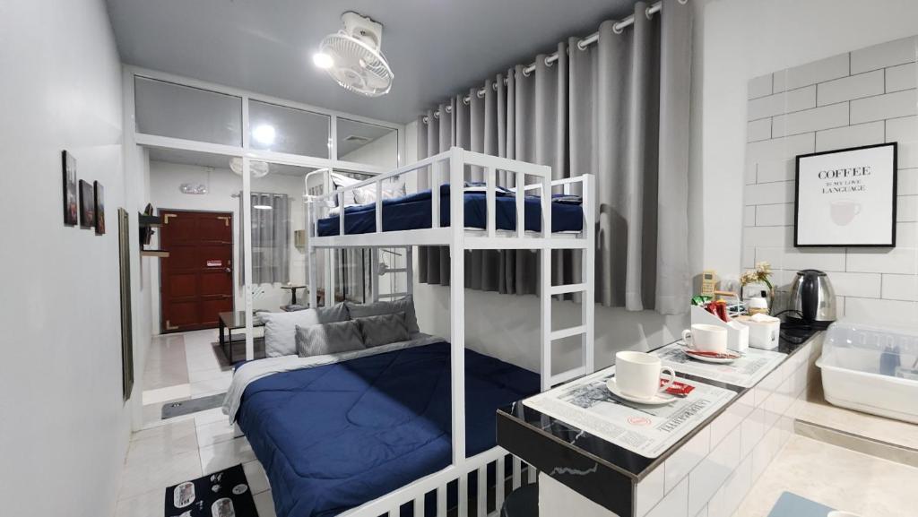 a small bedroom with a bunk bed and a desk at 338 Studio in Ban Liam