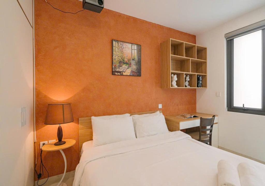 a bedroom with a large white bed and a desk at BOHO Homestay Hanoi - No81 Alley 8 Ton That Thiep in Hanoi
