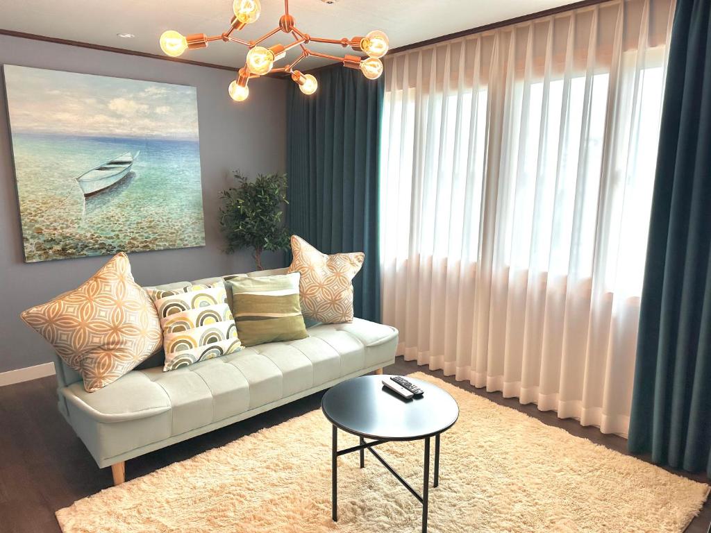 a living room with a white couch and a table at Seoungho Kim in Ch'ŏngsap'o