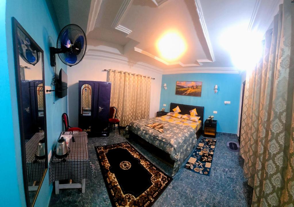 a bedroom with a bed in a blue room at Lavender Guesthouse in Cherrapunji