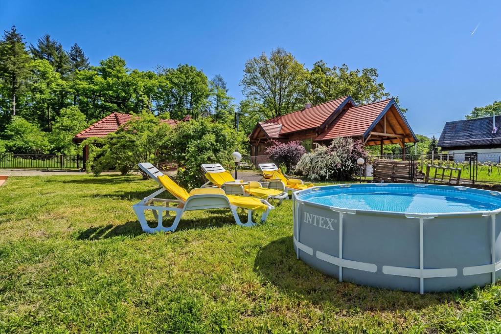 a group of chairs and a pool in a yard at Family Retreat near Zagreb with Pool & Garden - Happy Rentals in Velika Buna