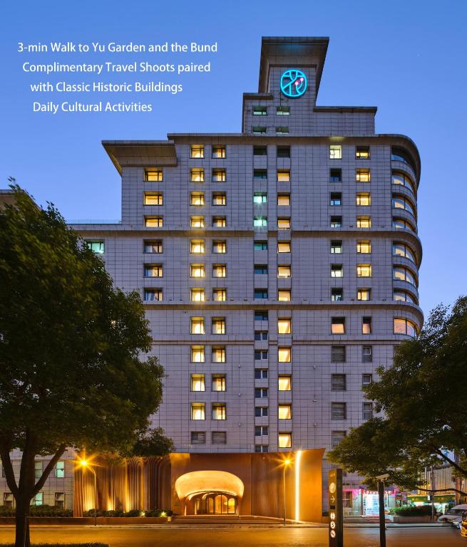 a large building with a clock on top of it at Blossom House Shanghai On The Bund in Shanghai