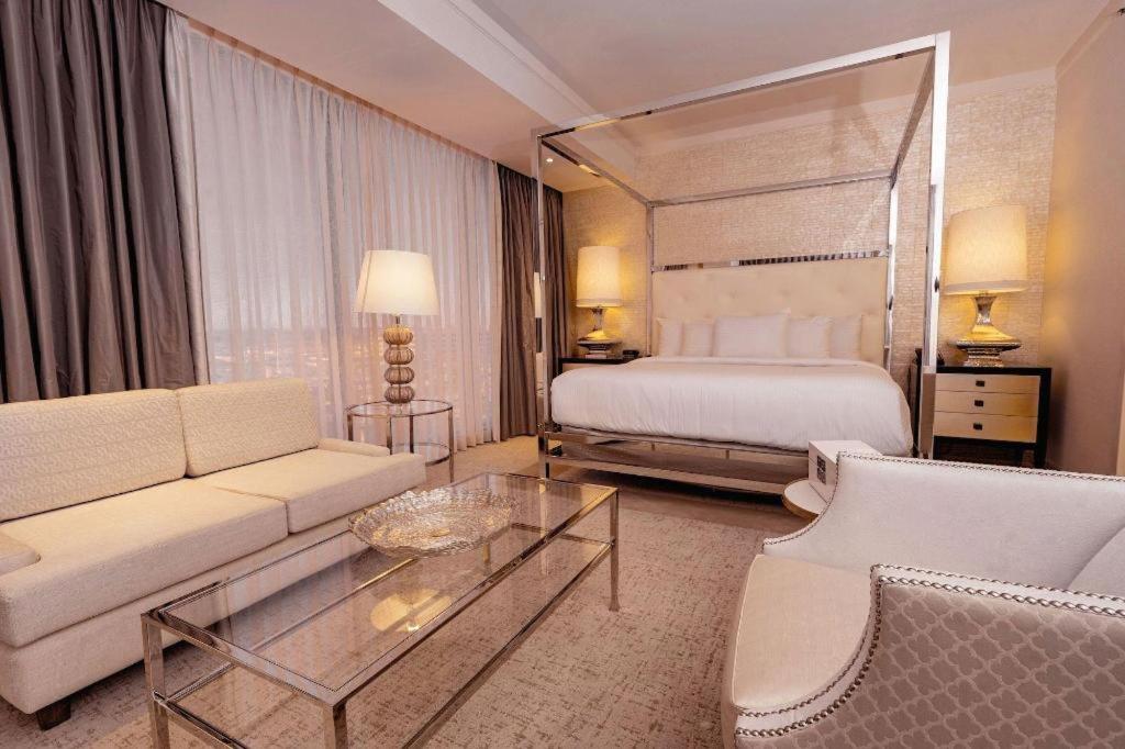 a hotel room with a bed and a couch and a table at Ahern Hotel and Event Center in Las Vegas