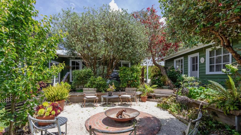 a patio with a table and chairs in a yard at Three Oaks in Red Hill