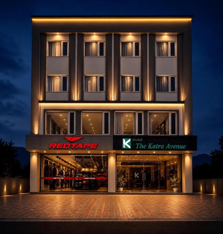 a hotel building with a sign in front of it at Hotel The Katra Avenue in Katra