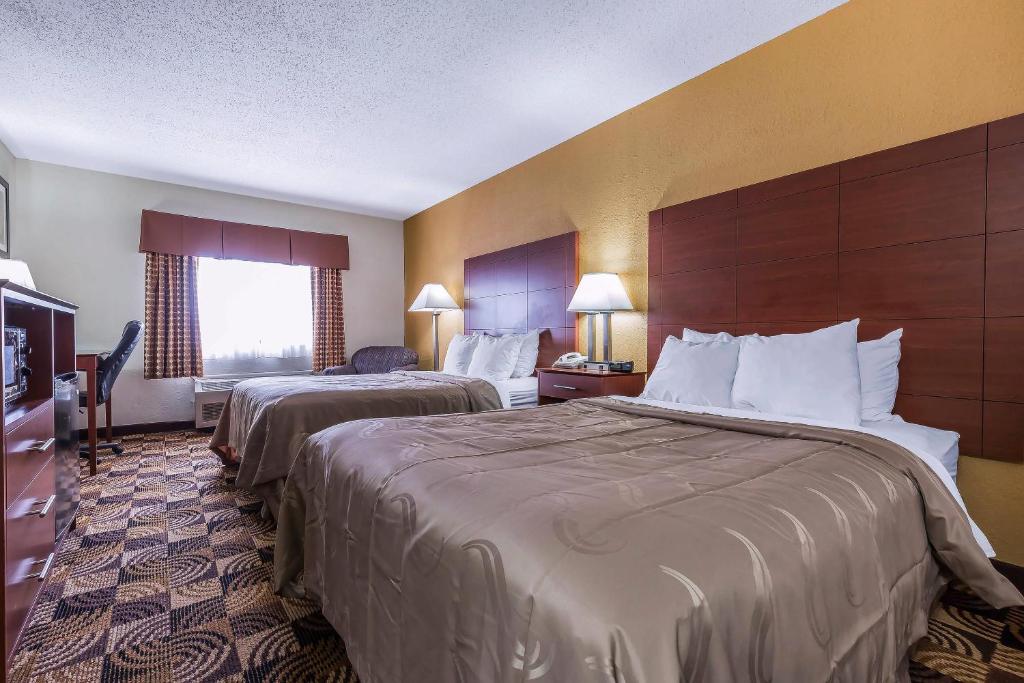 a hotel room with two beds and a television at Quality Inn Sycamore - DeKalb in Sycamore