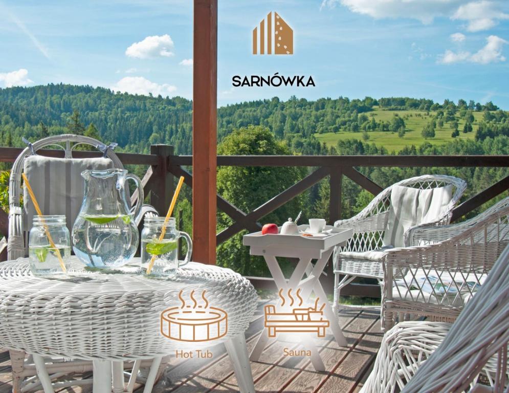 a table and chairs on a patio with a view at Sarnówka KDN in Rajcza