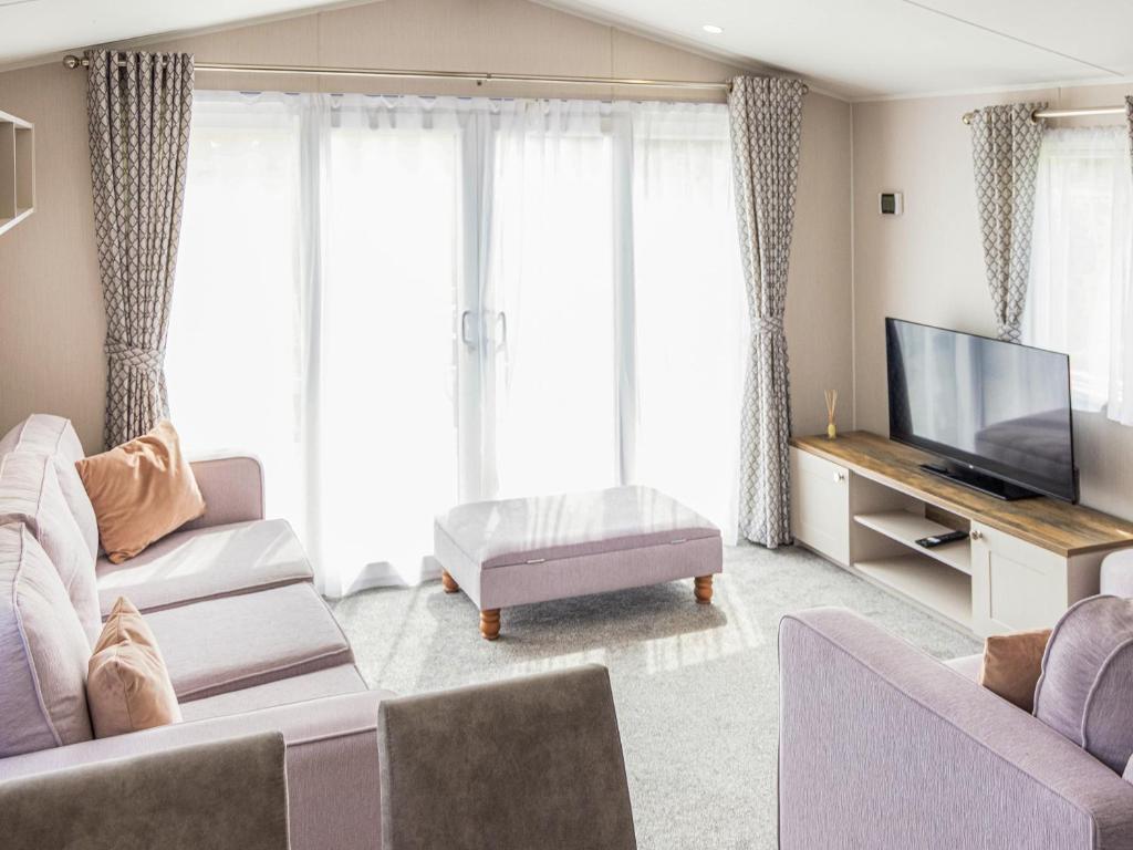 a living room with two couches and a flat screen tv at Luna - Ukc9719 in Aston
