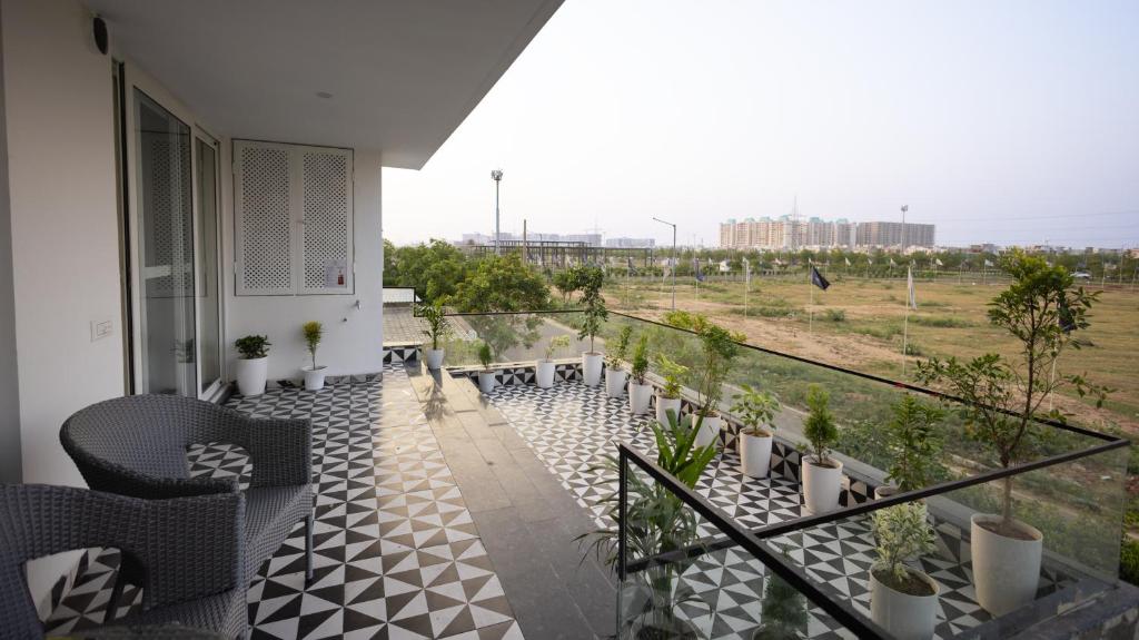 a balcony of a house with a view of a field at The Afternoon Stays in Mohali