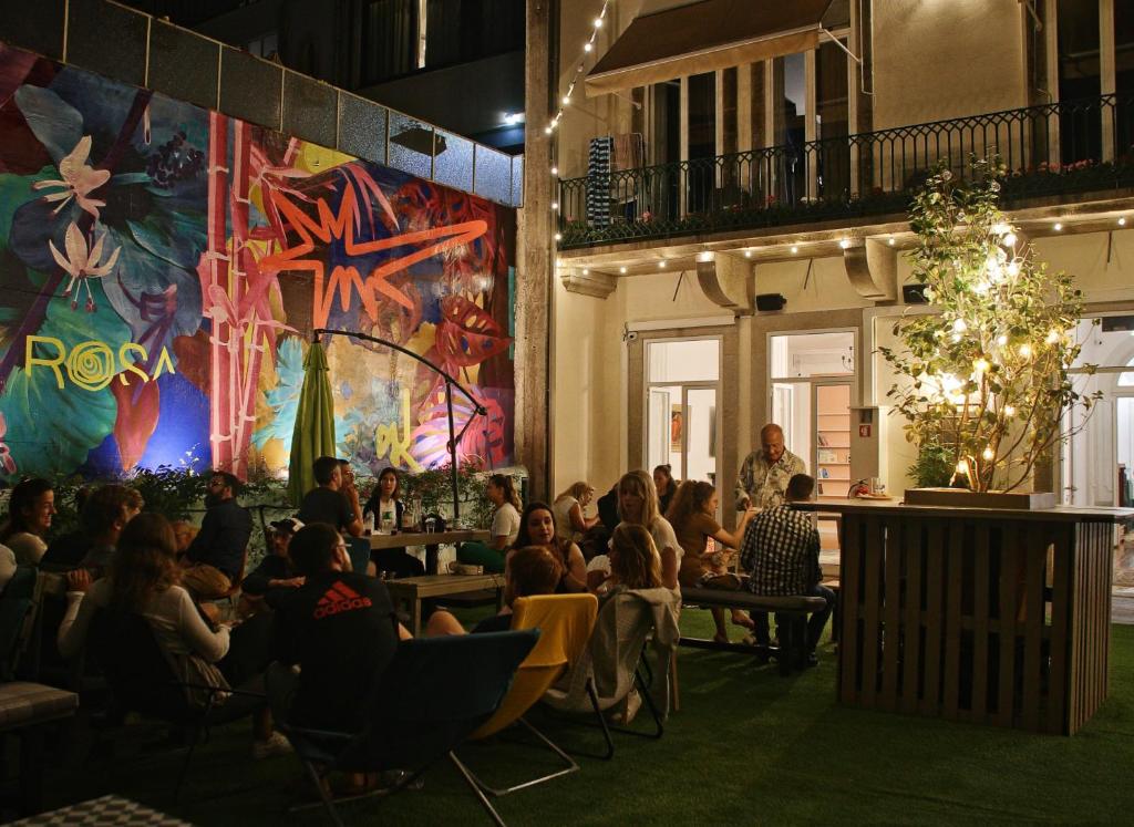 a crowd of people sitting in a restaurant at Rosalma Hostel in Porto