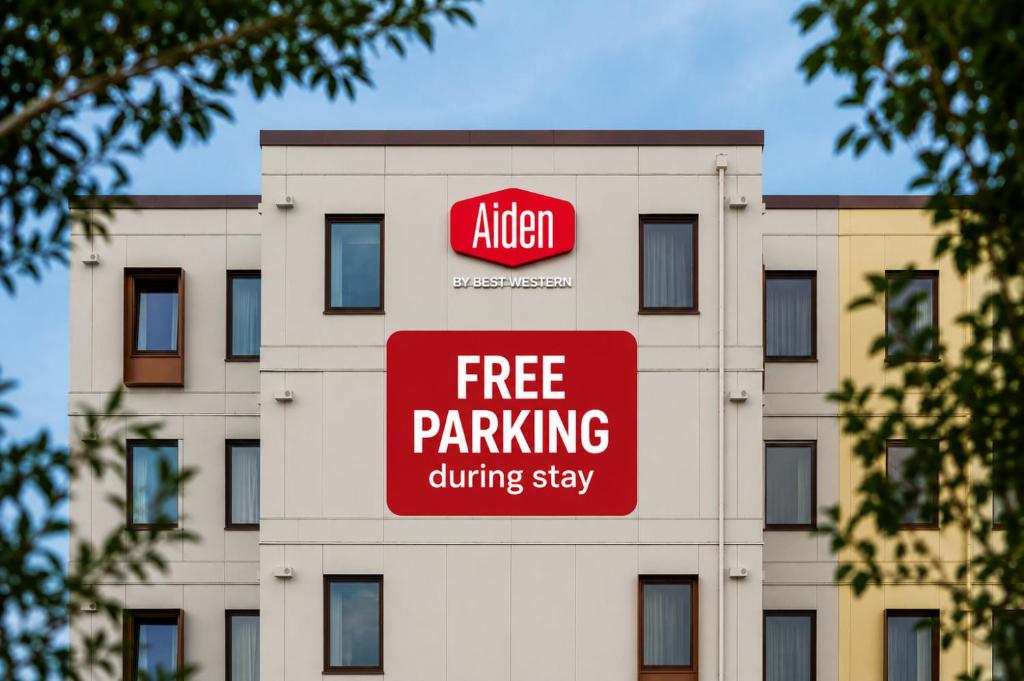 a building with a free parking sign on it at Aiden by Best Western Odense in Odense