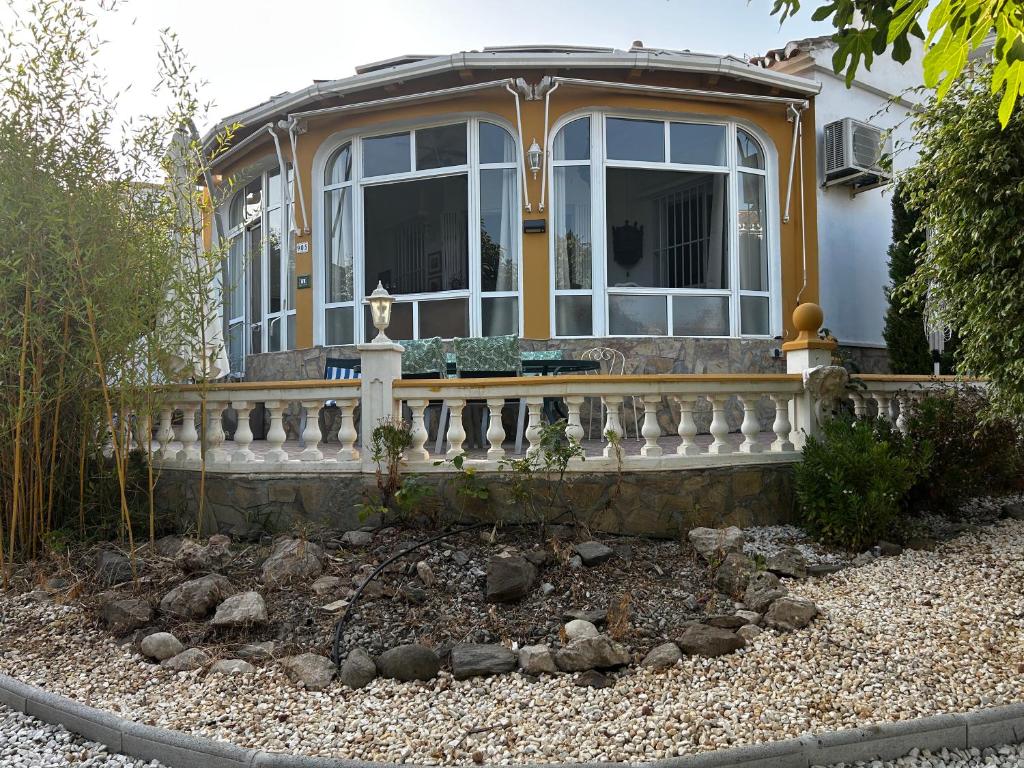 a house with a large window and a fence at Villa Carmen in Torrox Costa