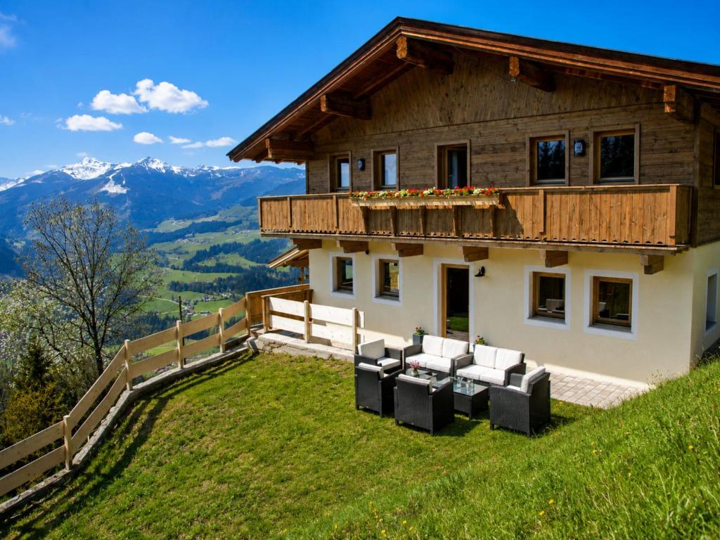 a house on a hill with couches on the grass at Chalet in Hopfgarten in Hopfgarten im Brixental