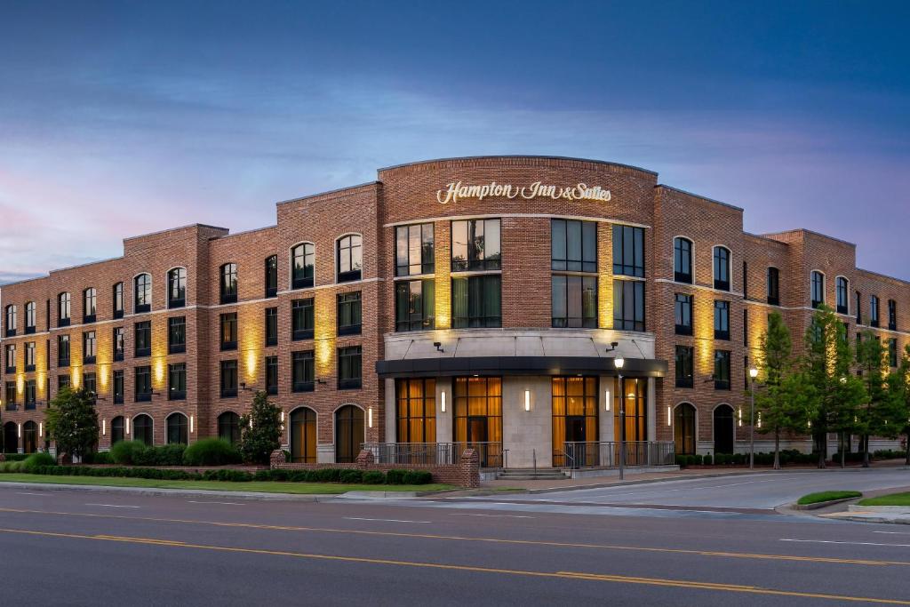 a large brick building on a city street at Hampton Inn & Suites Memphis Germantown in Memphis