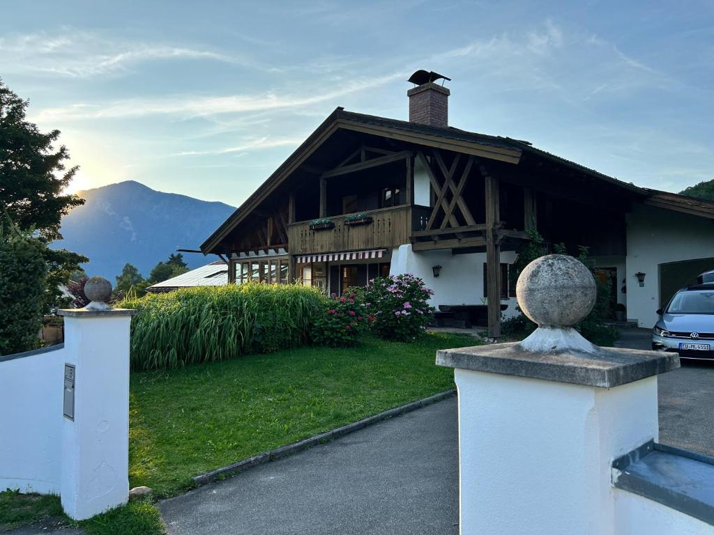 a house with a fence in front of it at Ferienhaus mit Bergpanorama in Unterwössen
