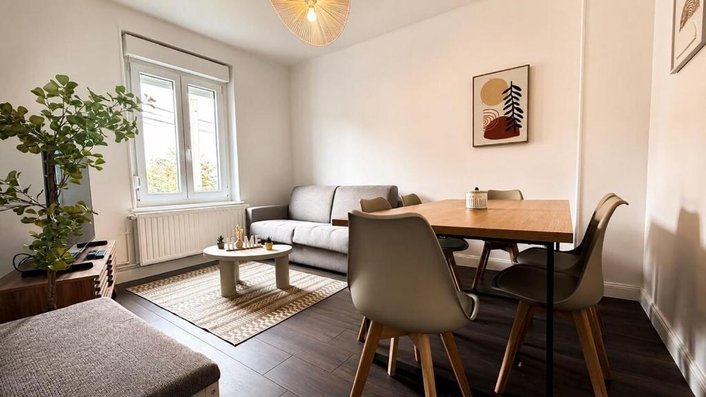 a living room with a table and a couch at Maison Luma in Basse-Yutz