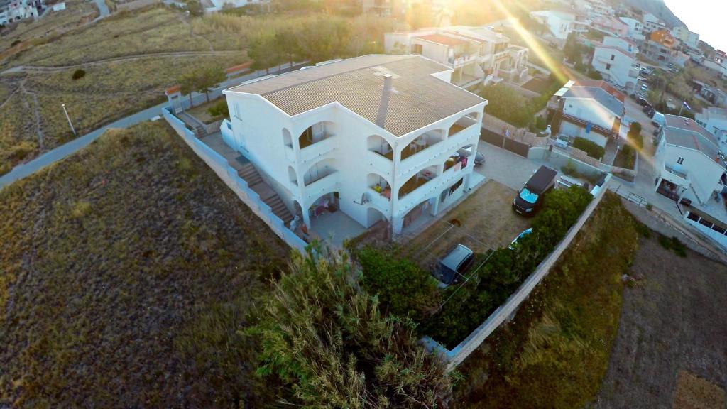 an overhead view of a white house with a roof at Apartments Alma in Pag