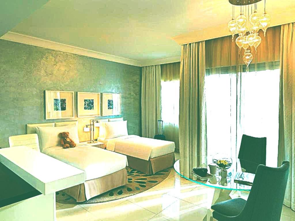 a hotel room with two beds and a desk at Hotel- M8 in Kota