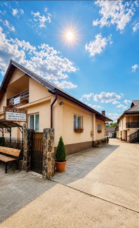 a building with a bench in front of it at Casa Vlad-Alex in Săpânța