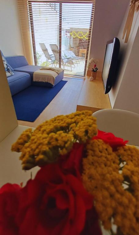 a teddy bear sitting on a table in a living room at Refúgio Brisa Mar in Vila do Conde