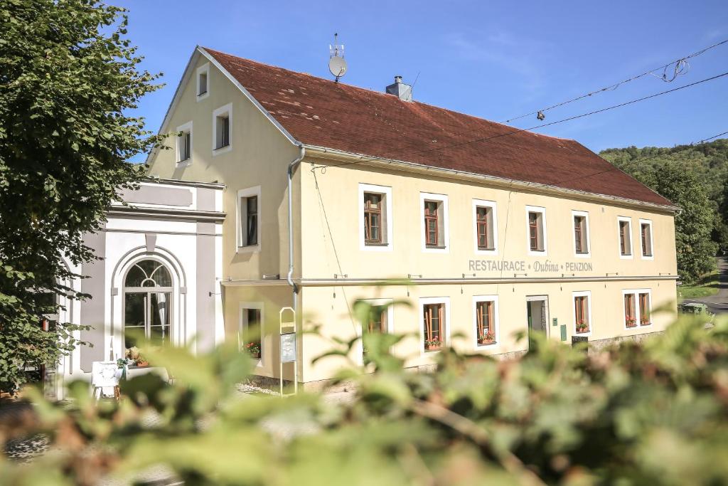 a large white building with a brown roof at Dubina in Kysibl Kyselka