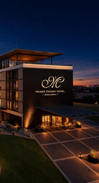 a building with a sign on the side of it at Meiser Design Hotel in Dinkelsbühl