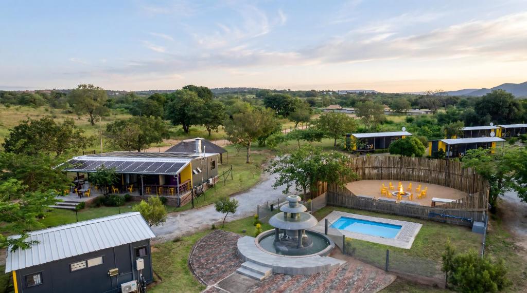 an aerial view of a home with a pool and a yard at SleepOver Phabeni in Hazyview
