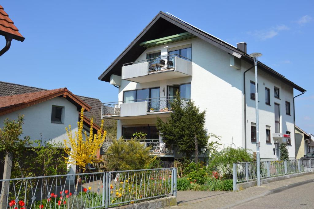 a white apartment building with a balcony at Ferienwohnung Diana in Rust