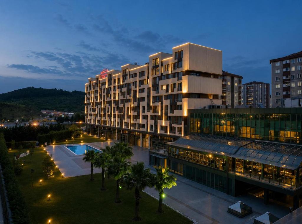 a building with a pool in front of a building at Miracle Istanbul Asia Airport Hotel & Spa in Istanbul