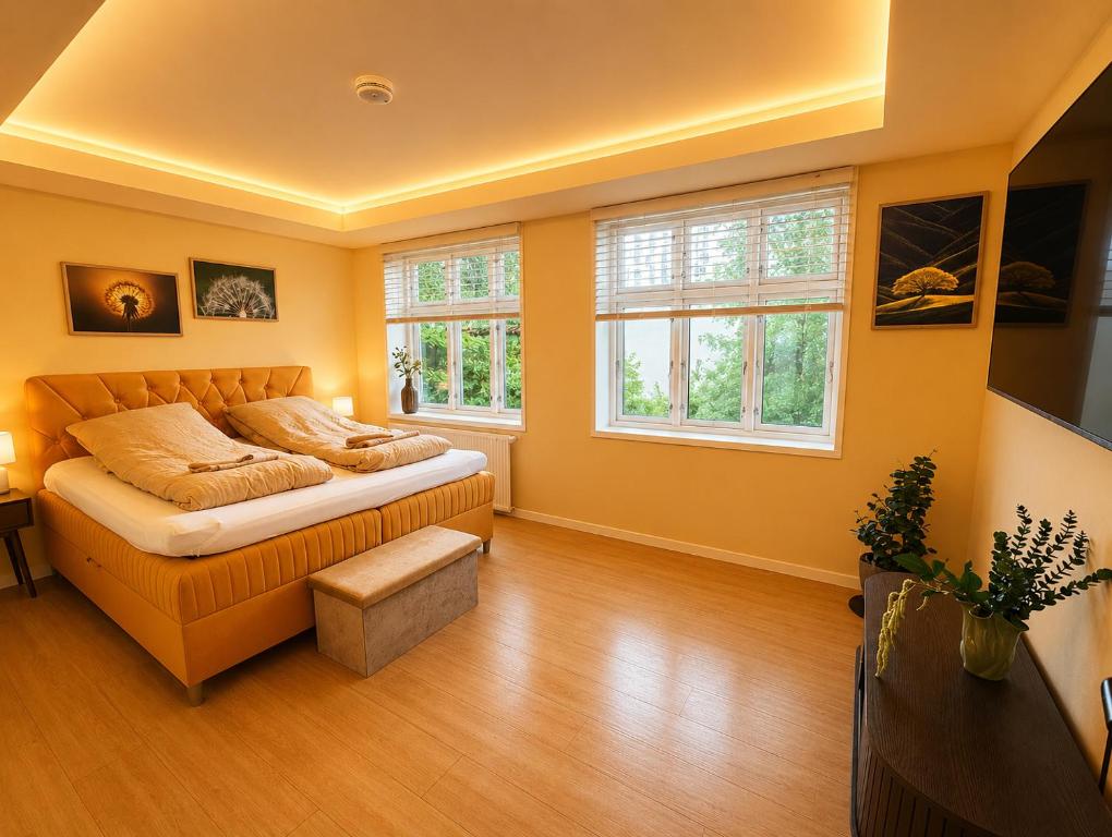 a bedroom with a bed and two windows at 4SEASONS - Golden Spring Suite in Aalborg