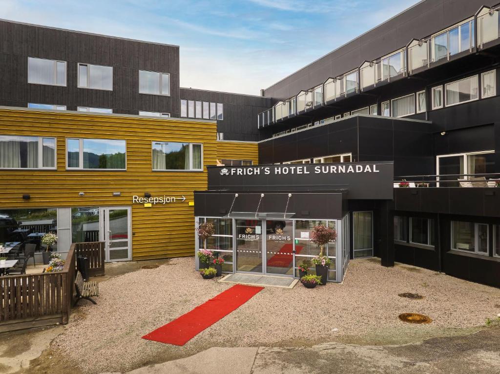 a store front of a building with a red carpet at Frich`s Hotel Surnadal in Surnadal