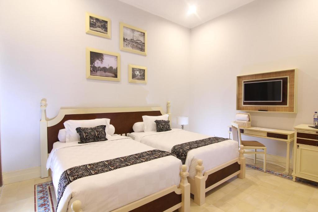 Postel nebo postele na pokoji v ubytování Java Villas Boutique Hotel & Resto