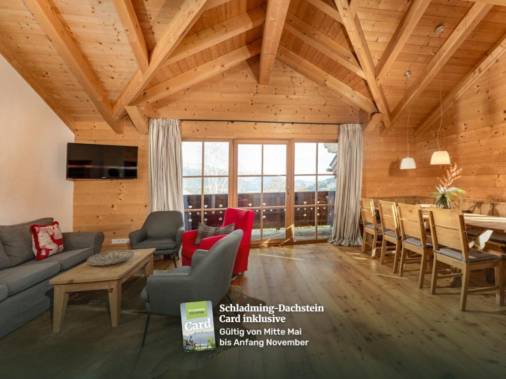 a living room with a couch and a table at Ski in/Ski out Chalets Tauernlodge by Schladming-Appartements in Schladming