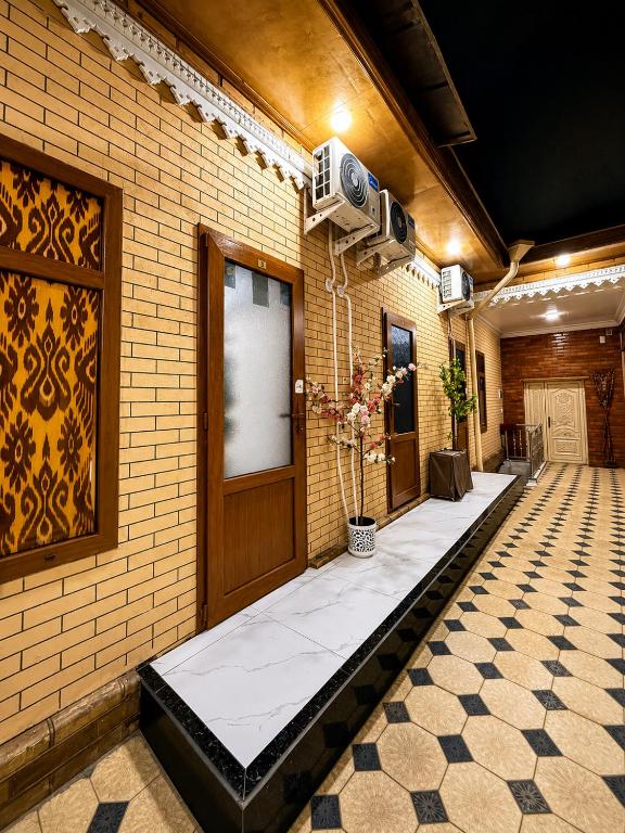 a hallway of a building with a door and a tile floor at Shahina in Samarkand